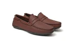 Close up of tan leather penny loafers with moccasin toe stitching and strap detail