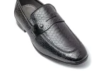 Close up photo of distressed black leather slip on loafers with moccasin toe