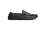 Close-up view of black leather slip-on loafers featuring moccasin-style stitching and saddle embellishments.