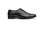 Close up of sleek black leather oxford shoes with minimalist lace-up detailing