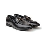 Close up of black leather loafers with silver metal bit accent