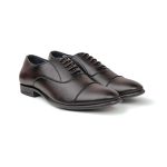 Close up of brown leather oxford dress shoes with intricate brogue perforations