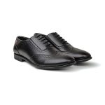 Close up of black leather brogue shoes with perforated detailing and black laces