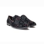 Black leather loafers with complicated gold embroidery elaborations on the toes and heels.