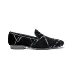 Black leather slip-on shoes for men with gold embellishments on the toes.