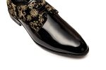 The slip-on footwear are black leather-based with gold floral embroidery.The embroidery on the footwear is complex and ornaments the toes and heels.