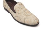 White leather loafers with problematic gold embroidery elaborations on the toes and heels.